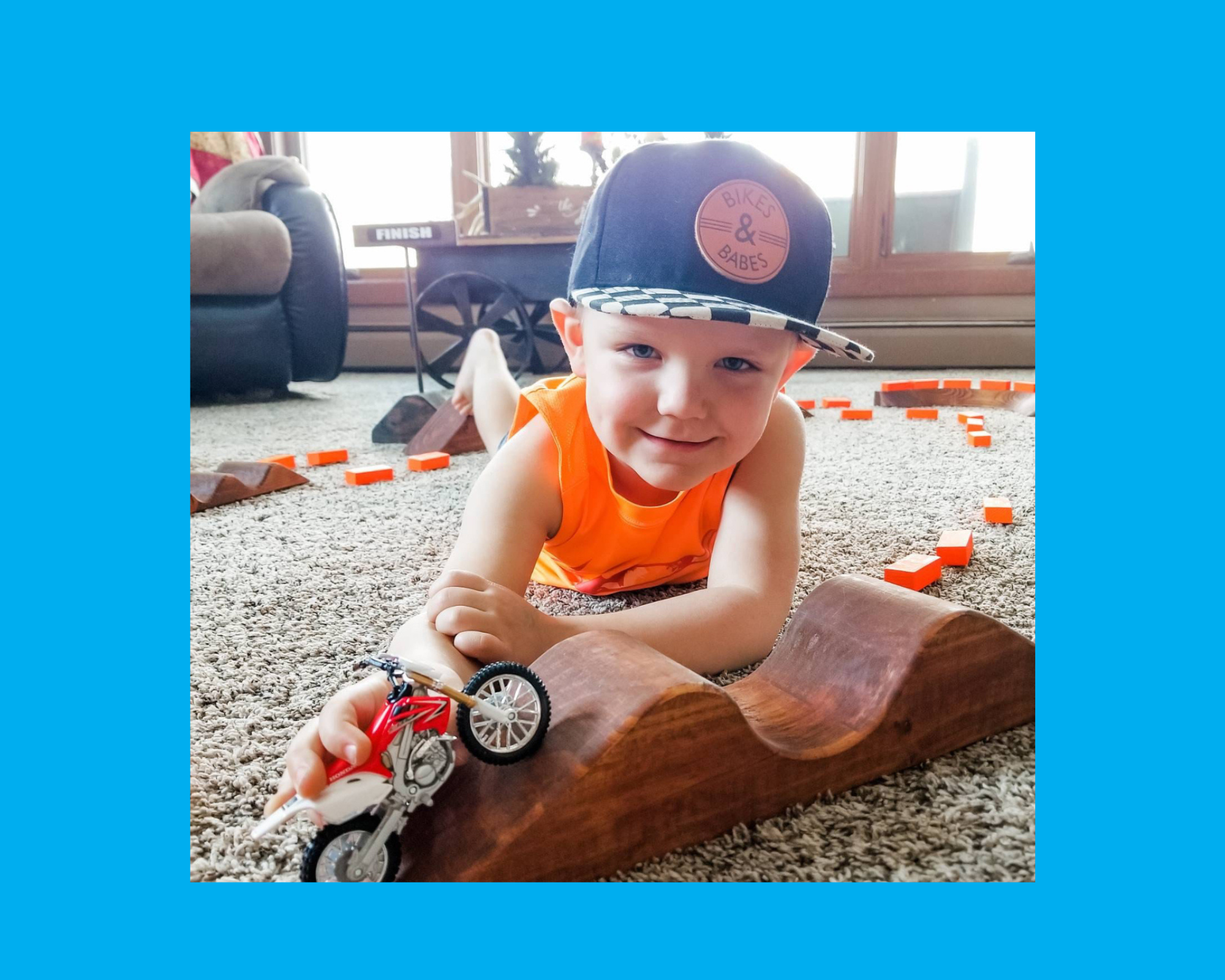 happy toddler boy playing with dirt bike
