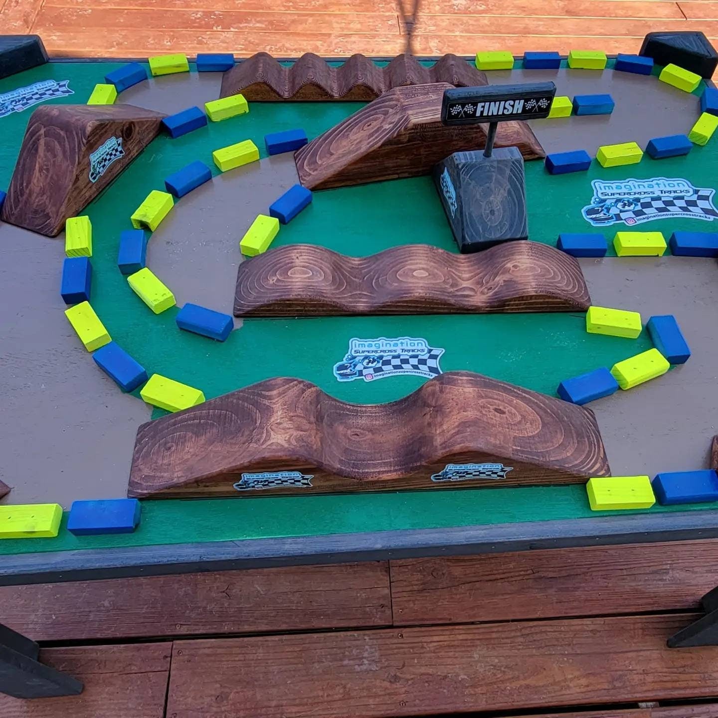 imagination supercross, woodshop, dirt bike rider, wood shop, dirtbike helmet, neon blocks on track table