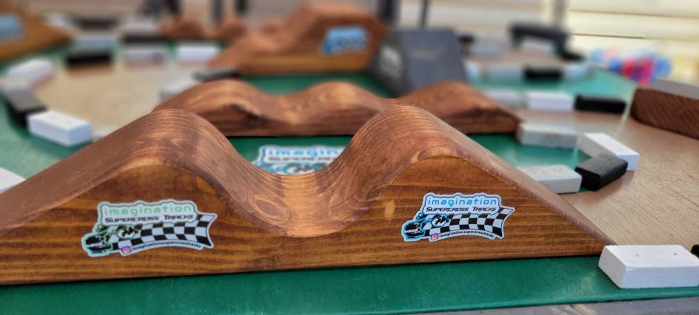 imagination supercross, woodshop, dirt bike rider, wood shop, dirtbike helmet, neon blocks on track table, double section