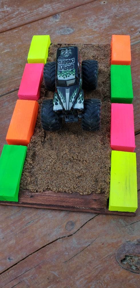 sand section with neon blocks with blue dirt bike rider and dirt bike, 4 wheeler