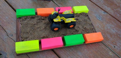 sand section with neon blocks with blue dirt bike rider and dirt bike, 4 wheeler